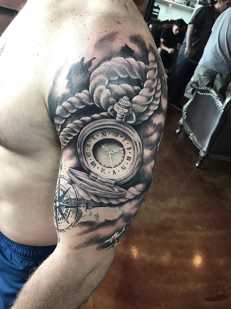 Black and grey half sleeve with a pocket watch and clouds