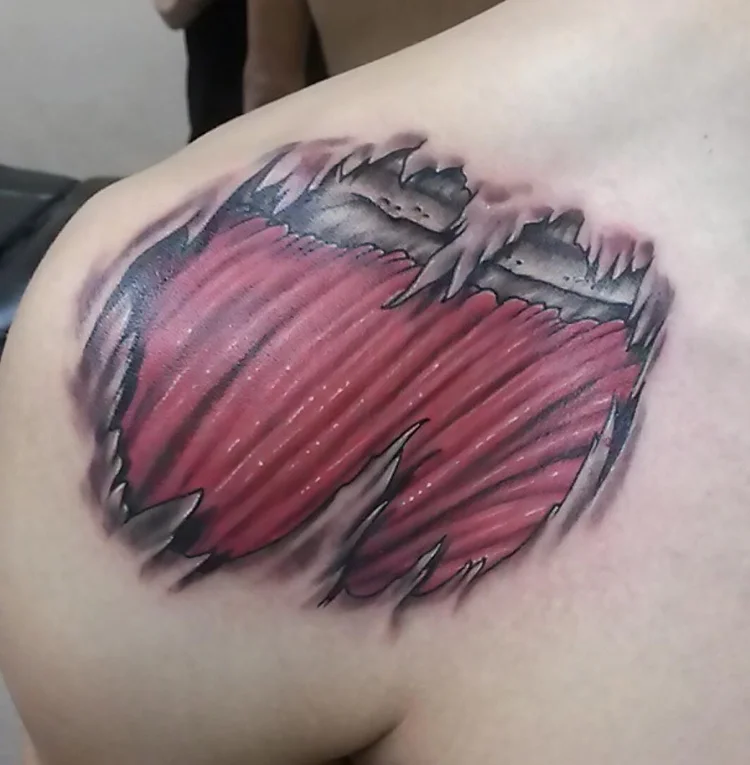 Color torn-skin muscle effect tattoo on the shoulder