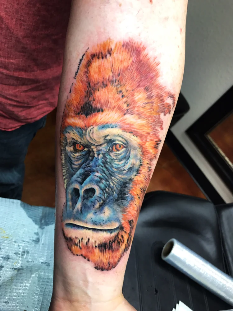 Color orangutan portrait on the forearm