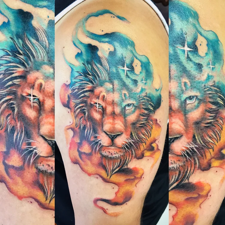 Watercolor lion tattoo on the upper arm